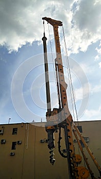 Drilling rig at work at a construction site. Vertical view