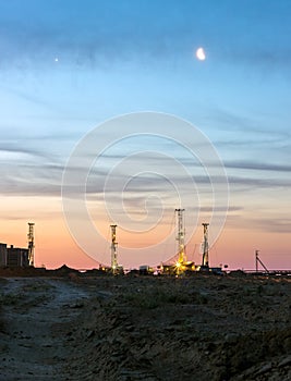 Drilling rigs at sunset.