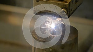 Drilling steel. Sparks fly in all directions. Electric tool cut and drill molds with oil. Close up.