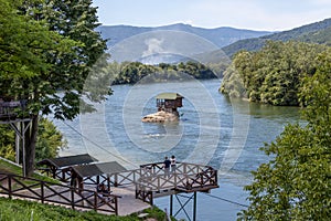 Drina river house is a wooden, cabin-like house on the rock in the middle of the Drina river, near the town of Bajina Basta in photo