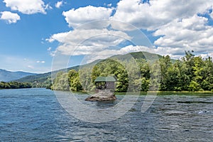 Drina river house is a wooden, cabin-like house on the rock in the middle of the Drina river, near the town of Bajina Basta in photo