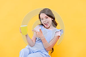 Drink it baby. Happy child point finger at cup yellow background. Little kid enjoy hot drink. Milk tea. Hot cacao or