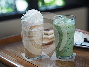 Drink Beverage, Iced Green Tea and coffee Cappuccino Smoothie topping with Whipped Cream in glass put on wooden table