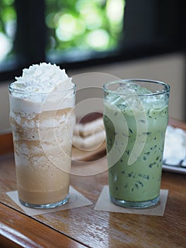Drink Beverage, Iced Green Tea and coffee Cappuccino Smoothie topping with Whipped Cream in glass put on wooden table