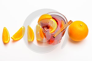 Drink or beverage with orange and cinnamon. Cocktail and bar concept. Mulled wine near slices of orange, top view. Glass