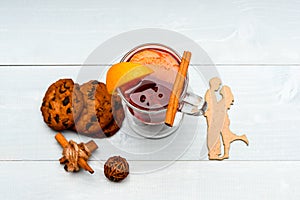 Drink or beverage with orange and cinnamon, top view. Date and drink concept. Mulled wine with cookies. Glass with