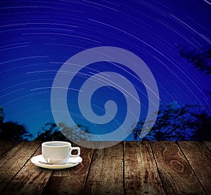 Drink coffee cup with star trails in night sky