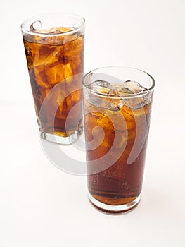 Drink cola with ice in glass on white background