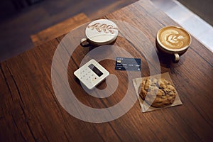 Drink And Cookie On Table In Coffee Shop With Contactless Payment Machine And Credit Card