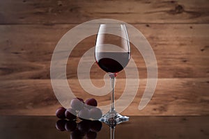 Drink and food. Wineglass, with red wine and red grapes