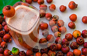 Drink and fruits of red araÃÂ§ÃÂ¡ Psidium cattleyanum on clear surface photo