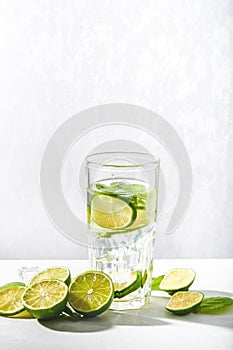 Drink glasses with water ,lime,mint and ice on white background