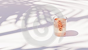 Drink with ice cubes in glass on white background with tropical leaf shadows, 3d render