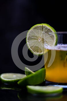 Drink, juice in a glass with a lemon slice, mint and cut lemons around