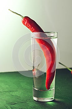 Drink set with shot of vodka and red pepper/ Drink set with shot of vodka and red pepper. Selective focus