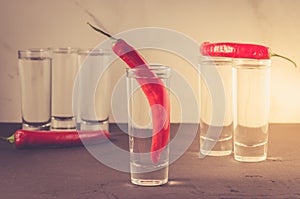 Drink set with shots of vodka and red pepper/Drink set with shots of vodka and red pepper. Selective focus. Toned