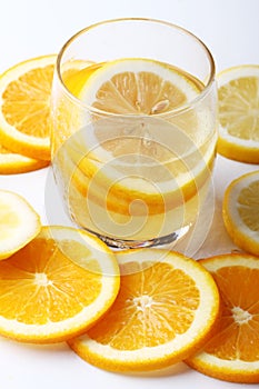 Drink and stack of citrus fruits slices. Oranges and lemons.