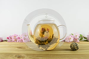 drink of tea with flower bloom inside a glass teapot