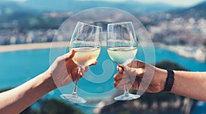 Drink two glasses white wine in friends hands outdoor sea nature holidays, closeup romantic couple toast with alcohol, happy