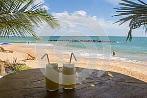Drink. View of nice tropical beach with palms around. photo
