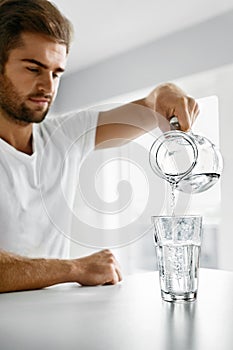 Drink Water. Close Up Man Pouring Water Into Glass. Hydration