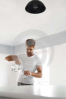 Drink Water. Close Up Man Pouring Water Into Glass. Hydration