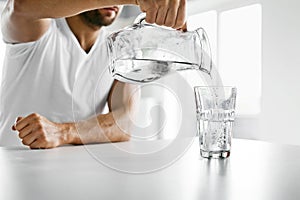 Drink Water. Close Up Man Pouring Water Into Glass. Hydration