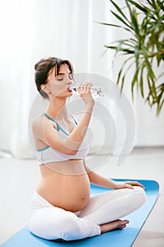 Drink Water. Pregnant Woman Drinking Water From Bottle