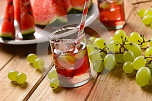 A drink of watermelon and grapes with ice cubes