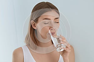 Drink. Woman drinking fresh pure water from glass portrait