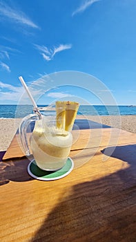 Drink on wooden table by the ocean