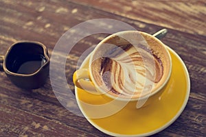Drinking coffee was decreased to half a cup on wooden table photo