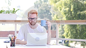 Drinking Coffee, Working Online on Laptop, Sitting in Outdoor Office, Red Hairs