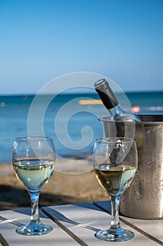 Drinking of cold white wine in beach bar, summer holidays, relax on sandy beach