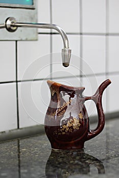 A drinking cup of mineral water in a pump room in Truskavets, Ukraine