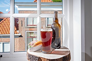 Drinking dark beer with smoked eel fish sandwich with view on street in old Zierikzee town, Zeeland, Netherland