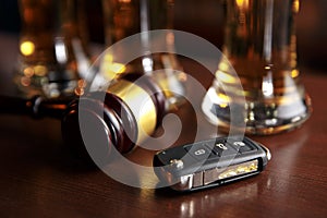 Drinking and driving concept. Car key on a wooden table, pub