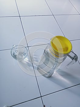 drinking equipment, a glass cup and a pitcher of water