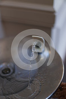 Drinking fountain with water spraying