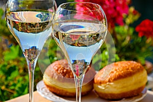 Drinking of French brut champagne sparkling wine with sweet apple Beignet, club party in yacht harbour of Port Grimaud near Saint-