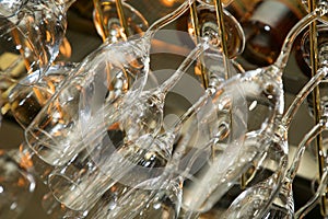 Drinking glasses hanging from a rack in a bar or restaurant.