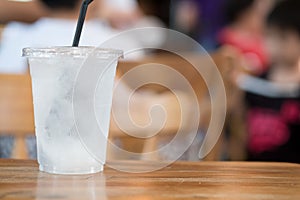 Drinking ice water with ice cube in plastic glass