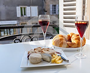 Drinking of Kir Royal,  French aperitif cocktail made  from creme de cassis topped with champagne, typically served in flute glass