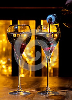 Drinking of Kir Royal, French aperitif cocktail made from creme de cassis topped with champagne, typically served in tulip glasses