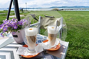drinking latte macchiato caffee together at lake Balaton in Hungary on the beach