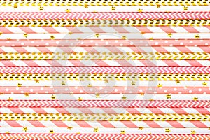 Drinking paper straws for party with golden, white, pink stripes on pink pastel background