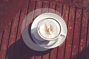 Drinking or refreshment concepts with white cup of coffee on wood table in the morning