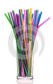 Drinking straws in glass over white