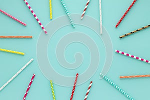 Drinking straws for party on blue pastel background with copy space.