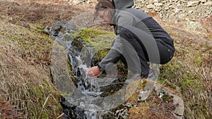 Drinking from a stream in Iceland